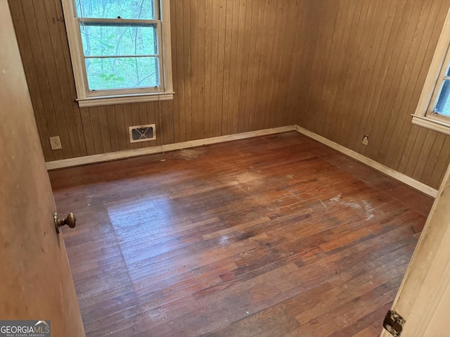4720 Ben Hill Rd, South Fulton, GA 30349 - spare room featuring healthy amount of natural light, hardwood / wood-style floors, baseboards, and wood walls