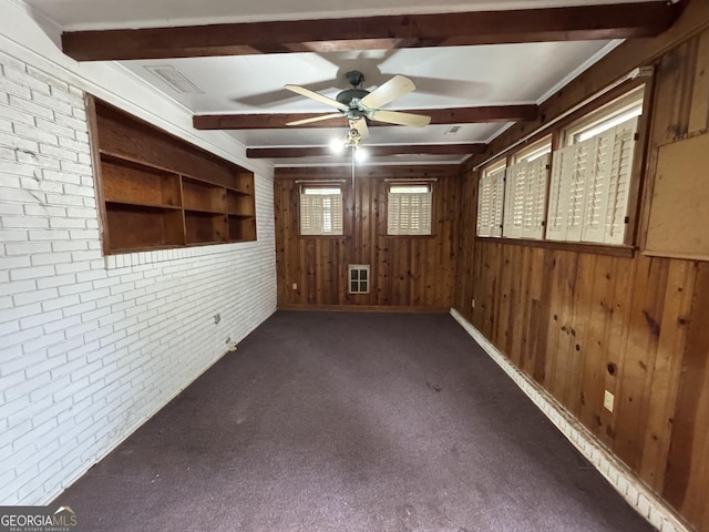 4720 Ben Hill Rd, South Fulton, GA 30349 - unfurnished room featuring beam ceiling, carpet, wood walls, ceiling fan, and brick wall