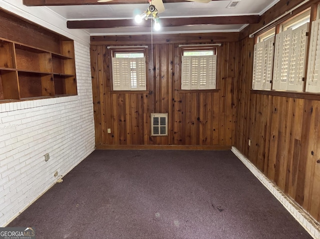 4720 Ben Hill Rd, South Fulton, GA 30349 - carpeted spare room with wood walls, beamed ceiling, ceiling fan, heating unit, and brick wall