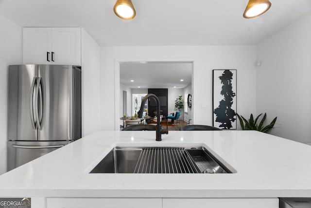 1870 Avon Ave SW, Atlanta, GA 30311 - kitchen with freestanding refrigerator, white cabinets, recessed lighting, open floor plan, and light stone counters
