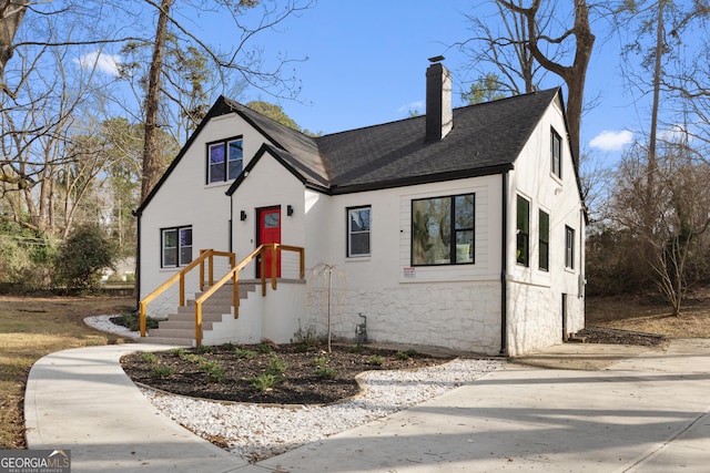 1870 Avon Ave SW, Atlanta, GA 30311 - view of front facade featuring a chimney, a shingled roof, and stone siding