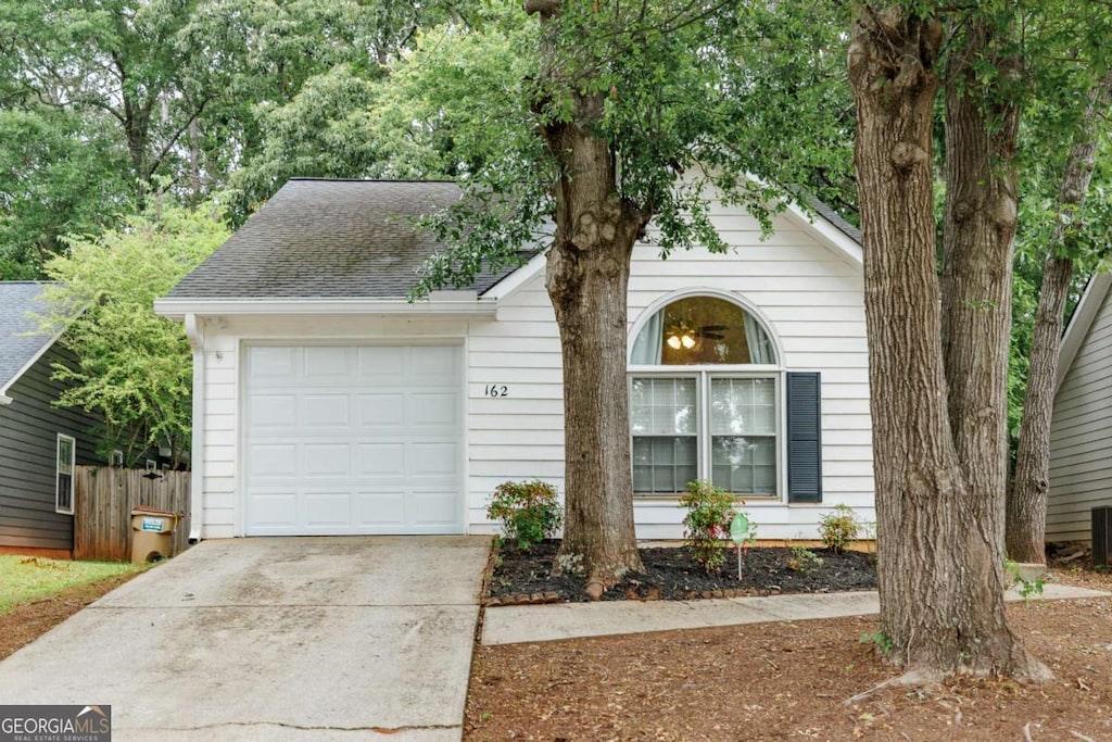 162 Wakefield Trce, Athens, GA 30605 - view of front of home featuring a garage, driveway, cooling unit, and roof with shingles