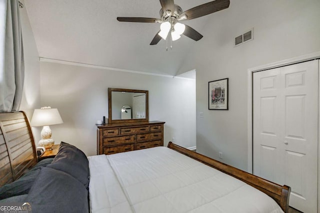 bedroom featuring lofted ceiling, a closet, and ceiling fan