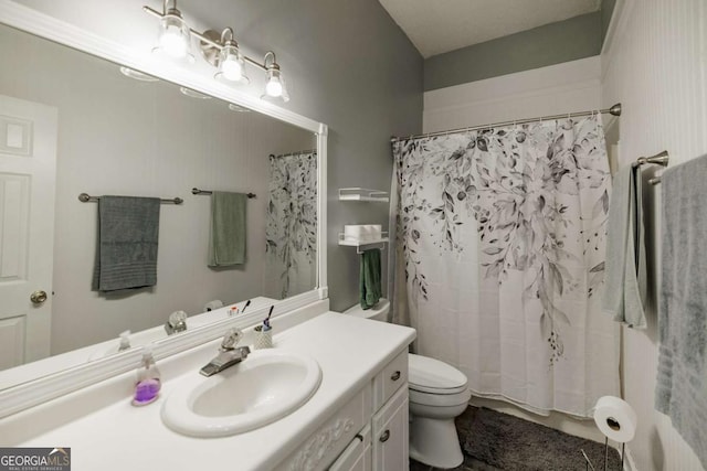 bathroom featuring vanity and toilet