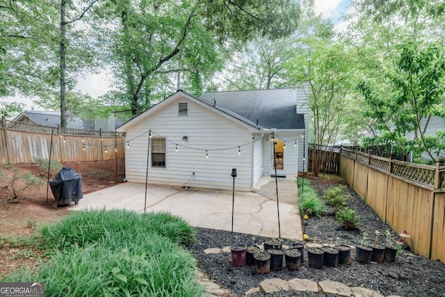 rear view of house featuring a patio area and a fenced backyard
