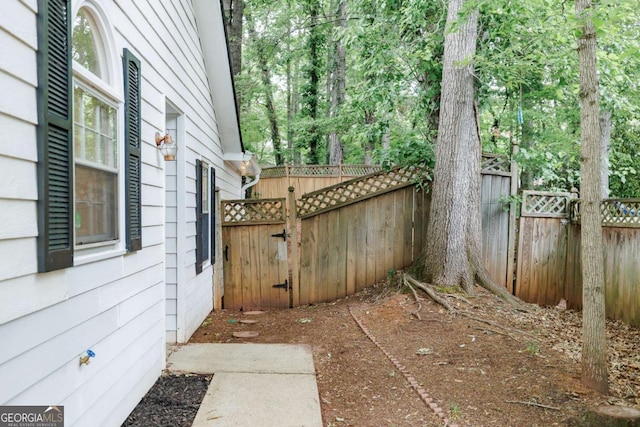 view of patio with a gate and fence