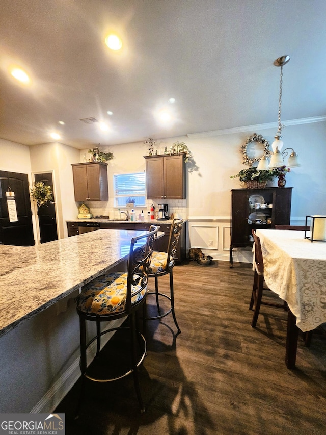 395 Brooks Village Dr, Pendergrass, GA 30567 - kitchen featuring light stone counters, dark wood-style floors, recessed lighting, black fridge, and a breakfast bar