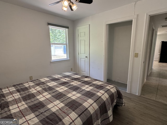13327 US Highway 17, Woodbine, GA 31569 - bedroom with freestanding refrigerator, wood finished floors, and ceiling fan