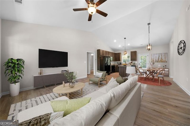 389 Campground School Rd, Dallas, GA 30157 - living area featuring vaulted ceiling, a ceiling fan, light wood finished floors, and baseboards