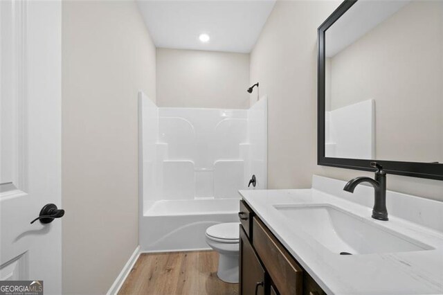 389 Campground School Rd, Dallas, GA 30157 - full bathroom featuring wood finished floors, toilet, vanity, shower / bathtub combination, and baseboards