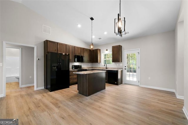 389 Campground School Rd, Dallas, GA 30157 - kitchen featuring black fridge with ice dispenser, range with electric cooktop, dark brown cabinets, a kitchen island, and lofted ceiling