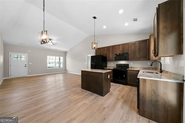 389 Campground School Rd, Dallas, GA 30157 - kitchen with black appliances, a sink, a kitchen island, lofted ceiling, and hanging light fixtures