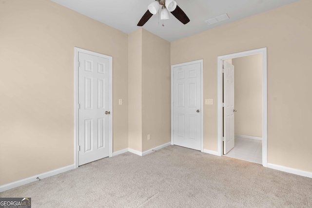 unfurnished bedroom featuring carpet, baseboards, and ceiling fan