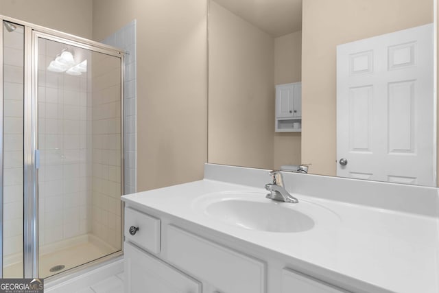 full bathroom with a stall shower and vanity