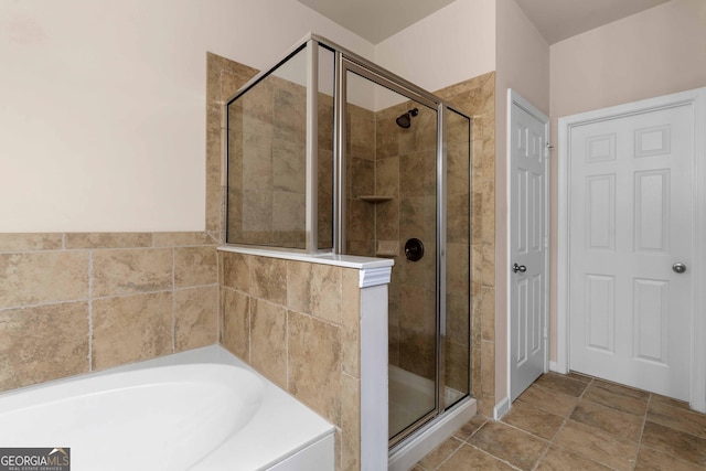 bathroom featuring a stall shower and a garden tub