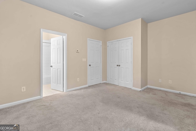 unfurnished bedroom featuring carpet flooring, baseboards, and connected bathroom