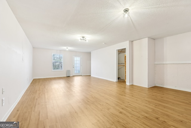 103 Timber Ridge Dr, Cartersville, GA 30121 - empty room featuring light wood finished floors, a textured ceiling, radiator heating unit, and baseboards
