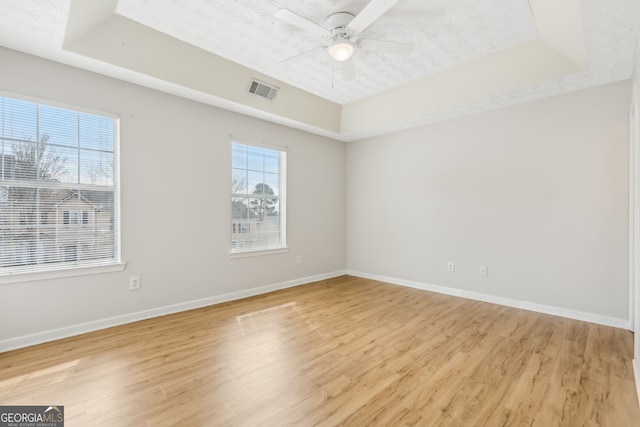 103 Timber Ridge Dr, Cartersville, GA 30121 - spare room featuring a raised ceiling, light wood-style floors, and baseboards