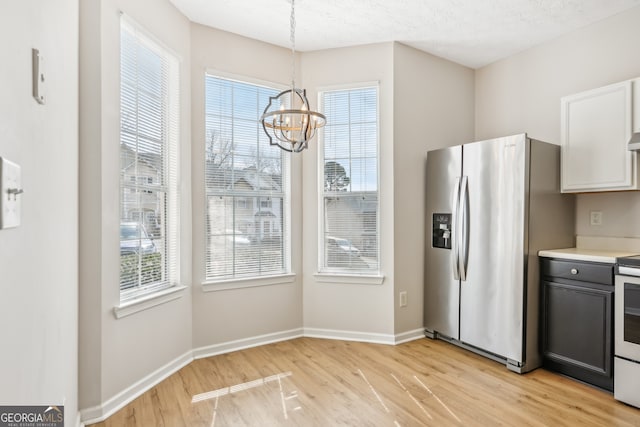 103 Timber Ridge Dr, Cartersville, GA 30121 - kitchen featuring stainless steel fridge, light wood-style floors, a chandelier, baseboards, and light countertops