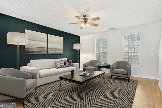 103 Timber Ridge Dr, Cartersville, GA 30121 - living area featuring wood finished floors, a ceiling fan, healthy amount of natural light, baseboards, and a textured ceiling