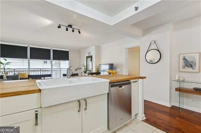 620 Peachtree St NE Unit 403, Atlanta, GA 30308 - kitchen featuring wood counters, stainless steel dishwasher, a sink, and track lighting