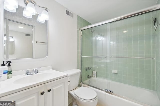 620 Peachtree St NE Unit 403, Atlanta, GA 30308 - bathroom with toilet, vanity, and bath / shower combo with glass door