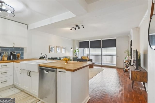620 Peachtree St NE Unit 403, Atlanta, GA 30308 - kitchen featuring butcher block countertops, dishwasher, a peninsula, a sink, and decorative backsplash