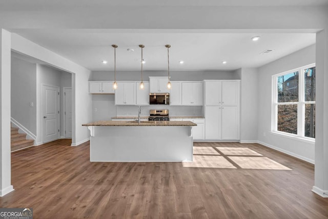 16 Grove Pointe Way SE, Cartersville, GA 30120 - kitchen with appliances with stainless steel finishes, baseboards, white cabinets, wood finished floors, and recessed lighting