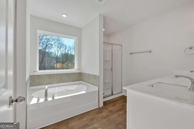 16 Grove Pointe Way SE, Cartersville, GA 30120 - full bath with a shower stall, wood finished floors, a sink, and a garden tub
