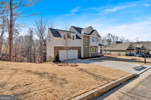 16 Grove Pointe Way SE, Cartersville, GA 30120 - view of front of home with stone siding, concrete driveway, an attached garage, and board and batten siding