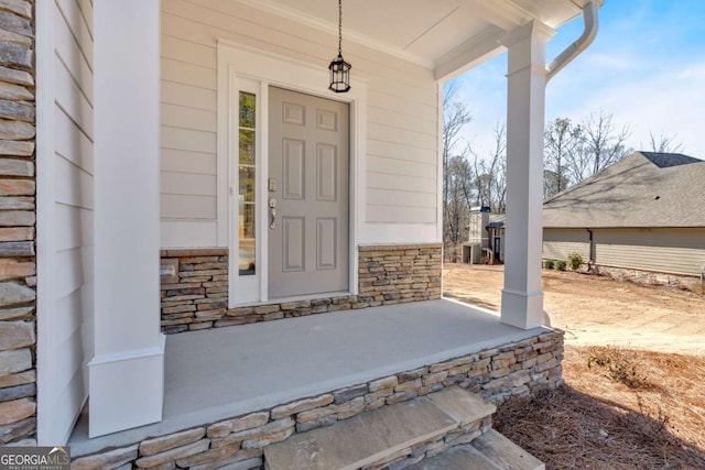 16 Grove Pointe Way SE, Cartersville, GA 30120 - doorway to property with covered porch, stone siding, and central air condition unit