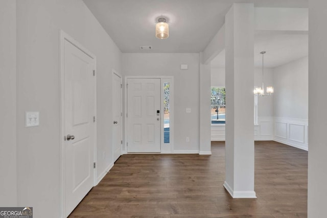16 Grove Pointe Way SE, Cartersville, GA 30120 - entrance foyer featuring dark wood finished floors, a chandelier, and a wainscoted wall
