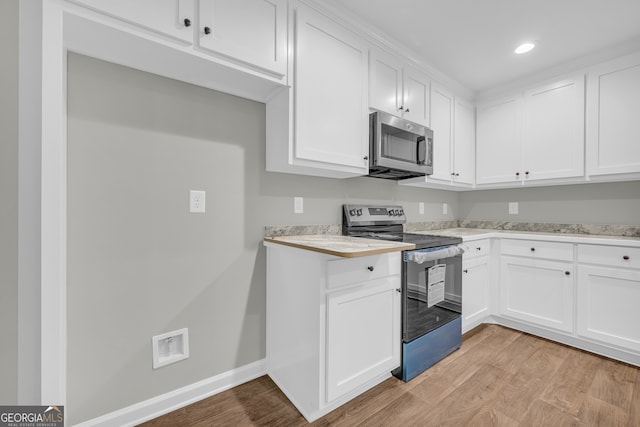 350 Maple St, Hartwell, GA 30643 - kitchen featuring stainless steel appliances, light countertops, light wood-style flooring, white cabinetry, and recessed lighting