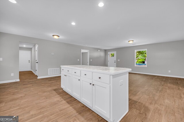 350 Maple St, Hartwell, GA 30643 - kitchen featuring white cabinets, light wood finished floors, a kitchen island, light countertops, and recessed lighting