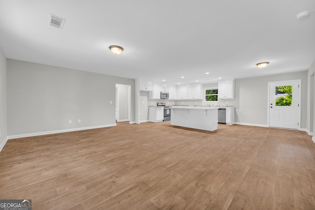 350 Maple St, Hartwell, GA 30643 - unfurnished living room with light wood-type flooring and recessed lighting