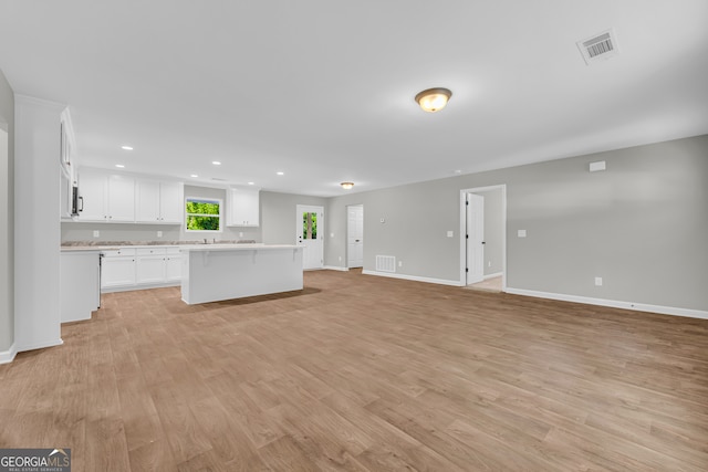 350 Maple St, Hartwell, GA 30643 - unfurnished living room featuring light wood finished floors and recessed lighting