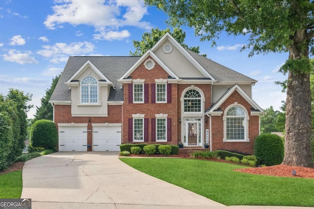 1316 Wind Chime Ct, Lawrenceville, GA 30045 - view of front of home featuring concrete driveway, a front yard, brick siding, and a garage