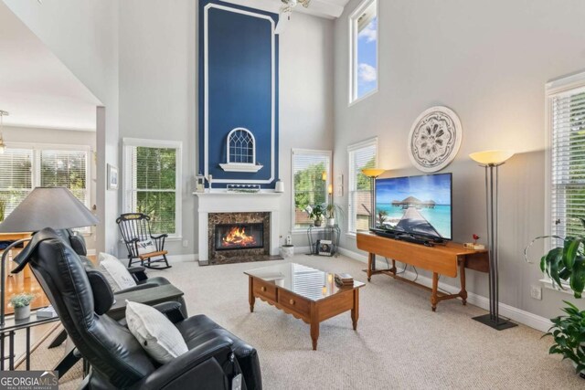 1316 Wind Chime Ct, Lawrenceville, GA 30045 - carpeted living area featuring a high ceiling, a fireplace, and baseboards