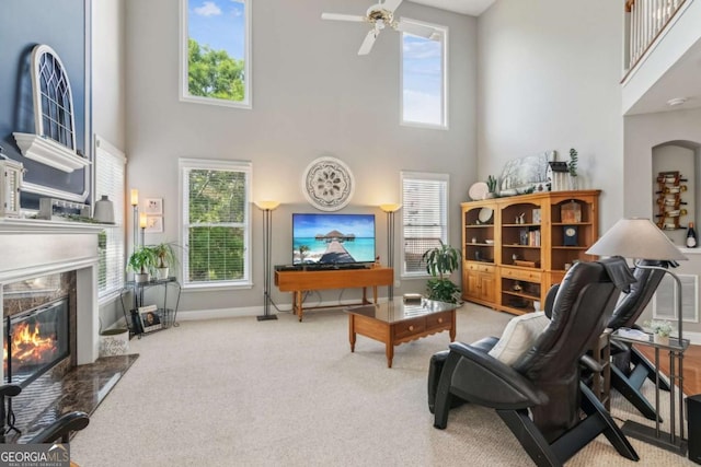 1316 Wind Chime Ct, Lawrenceville, GA 30045 - living area featuring a towering ceiling, a fireplace, carpet flooring, ceiling fan, and baseboards