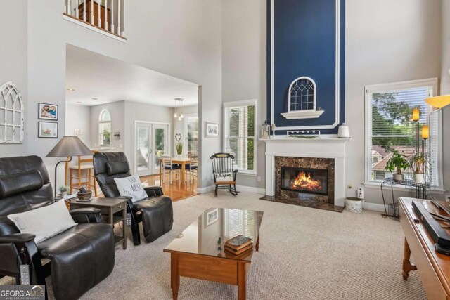 1316 Wind Chime Ct, Lawrenceville, GA 30045 - carpeted living area with a towering ceiling, healthy amount of natural light, a premium fireplace, and baseboards