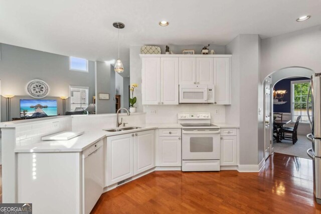 1316 Wind Chime Ct, Lawrenceville, GA 30045 - kitchen with white appliances, a sink, a peninsula, light wood-type flooring, and recessed lighting