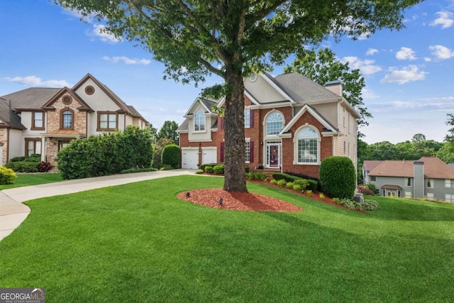1316 Wind Chime Ct, Lawrenceville, GA 30045 - view of front of house with driveway, a chimney, brick siding, an attached garage, and a front lawn