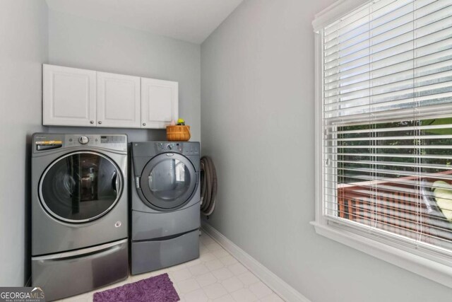 1316 Wind Chime Ct, Lawrenceville, GA 30045 - washroom with washer and clothes dryer, cabinet space, healthy amount of natural light, and baseboards