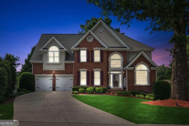 1316 Wind Chime Ct, Lawrenceville, GA 30045 - view of front of property featuring driveway, a lawn, brick siding, and a garage