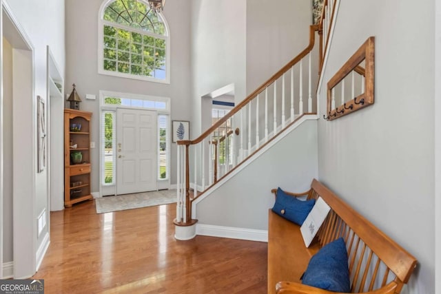 1316 Wind Chime Ct, Lawrenceville, GA 30045 - foyer entrance featuring wood finished floors, stairway, baseboards, and a towering ceiling