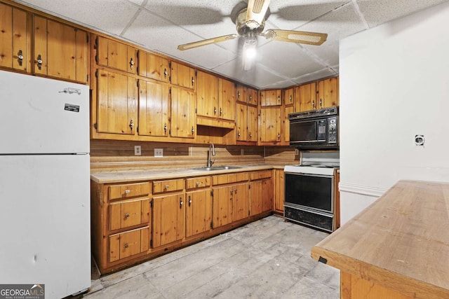 1909 Winding Creek Ln SW, Marietta, GA 30064 - kitchen with freestanding refrigerator, electric range, black microwave, a sink, and a drop ceiling