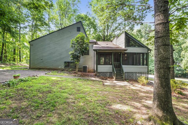 1909 Winding Creek Ln SW, Marietta, GA 30064 - view of front of house featuring a sunroom, central AC, and a front yard