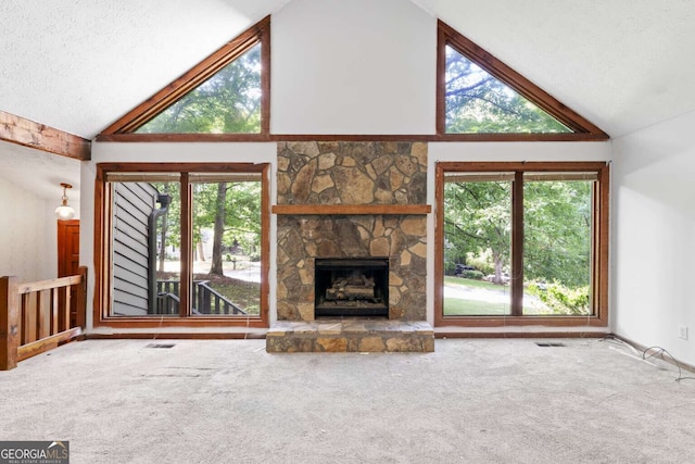 1909 Winding Creek Ln SW, Marietta, GA 30064 - unfurnished living room featuring carpet floors, high vaulted ceiling, a stone fireplace, and a textured ceiling