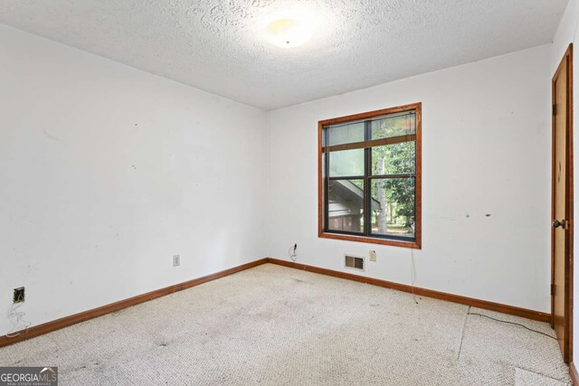1909 Winding Creek Ln SW, Marietta, GA 30064 - carpeted empty room featuring a textured ceiling and baseboards