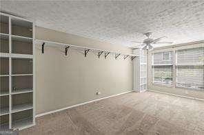 1371 Keys Lake Dr NE, Atlanta, GA 30319 - empty room with carpet flooring, baseboards, and a ceiling fan
